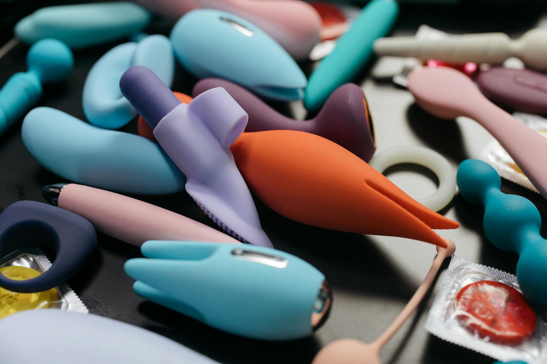 Colorful clitoral vibrators and pleasure devices on a bright yellow background