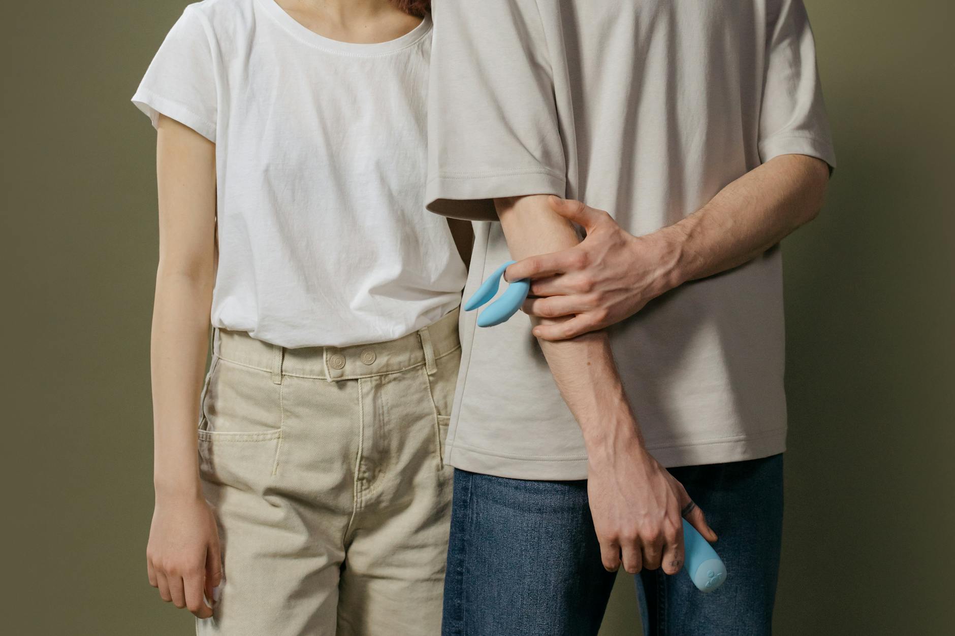 A blue silicone sex toy held in hand against a purple background, promoting self-love and sexual pleasure