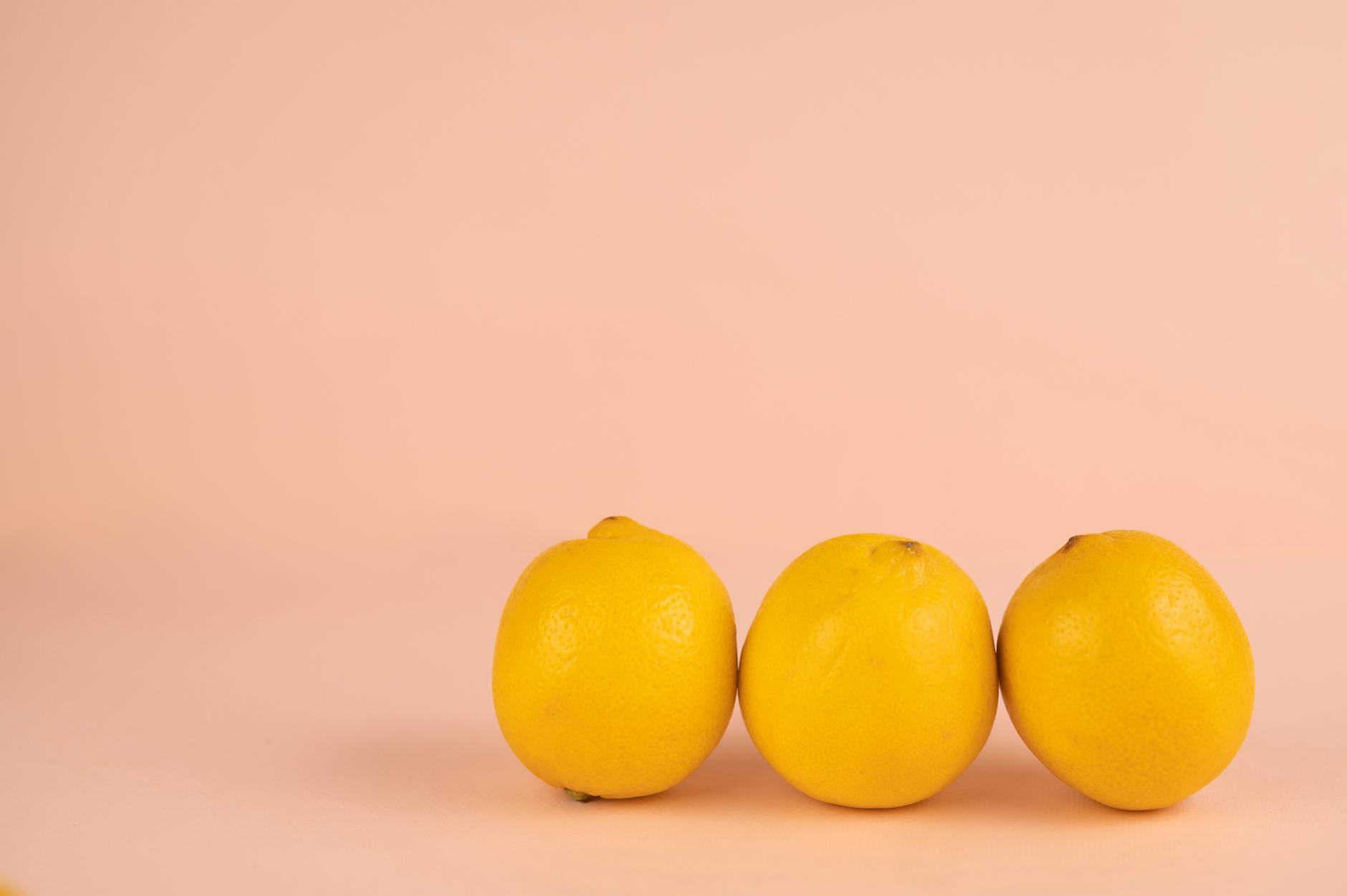 Bright ripe lemons arranged on a pastel background, representing fresh approaches to desire and sensuality