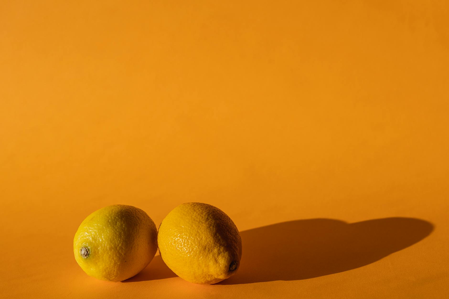Ripe vivid lemons composed on yellow background showing bright, fresh energy